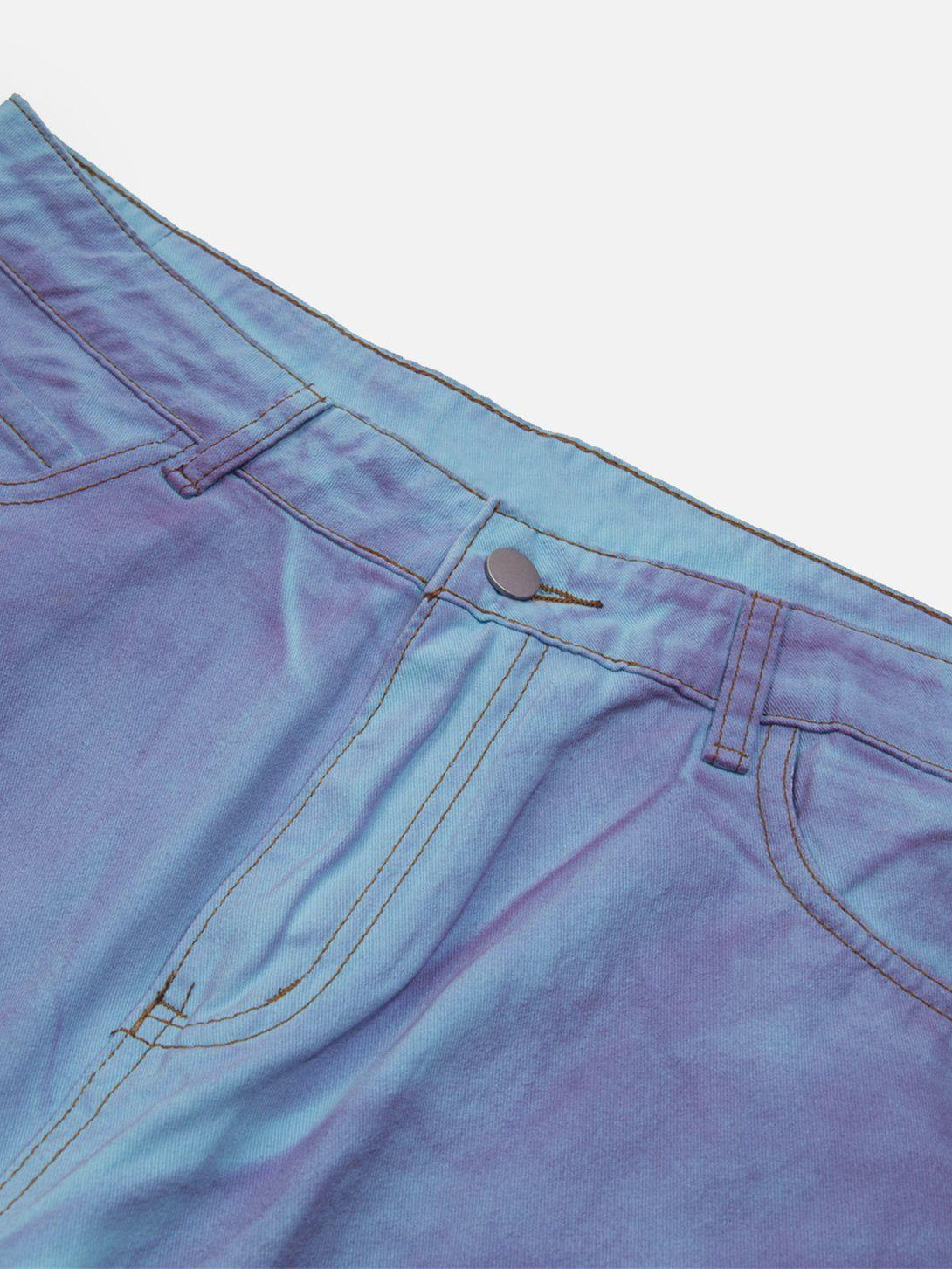 A close-up of TALISHKO's blue-purple loose jeans, highlighting the gradient waistband detail.
