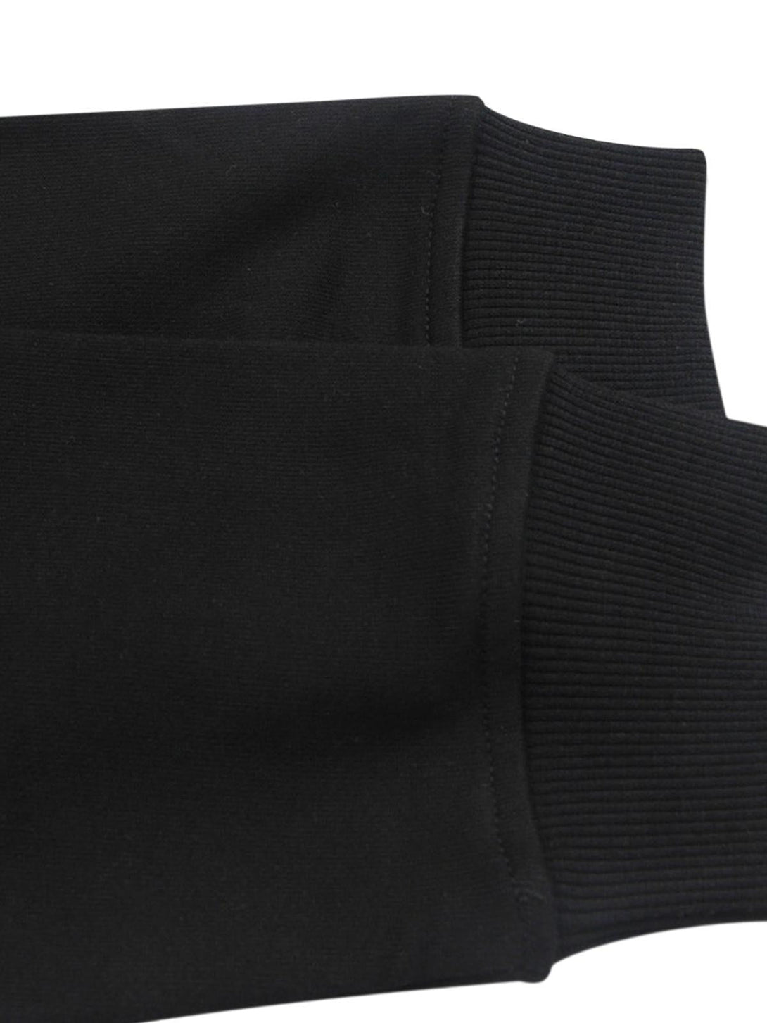 Intricate look at the ribbed cuffs on a black long sleeve T-shirt by TALISHKO.