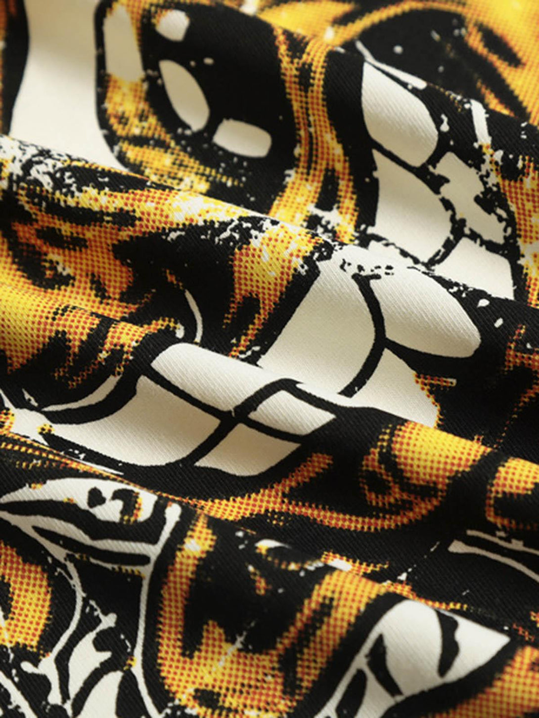 Intricate look at the bold artwork on TALISHKO's graphic T-shirt, emphasizing vibrant patterns.