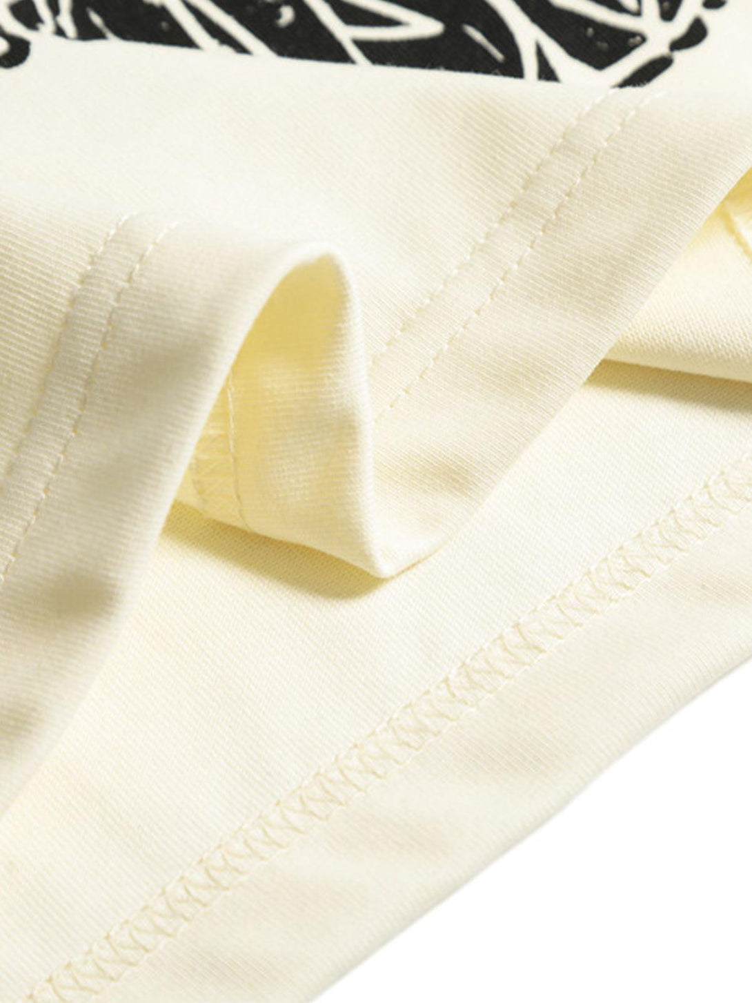 A detailed view of TALISHKO's graphic T-shirt fabric, highlighting quality stitching and texture.