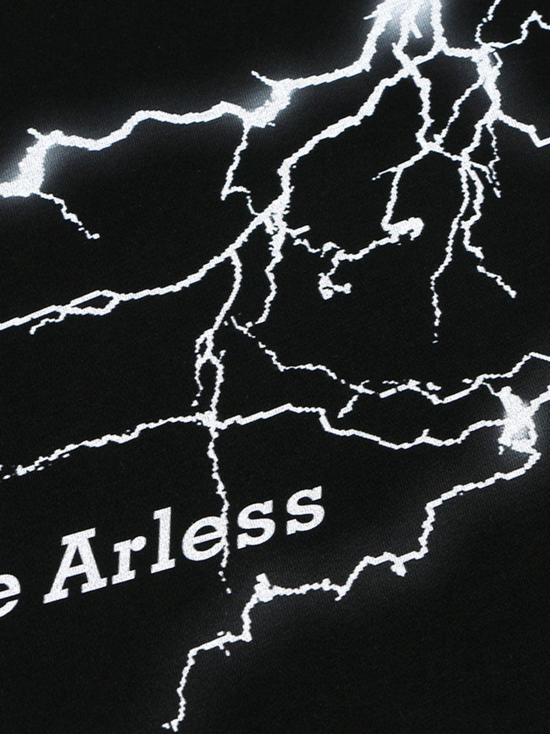 A detailed look at the lightning graphic on a TALISHKO black vest, emphasizing bold design.