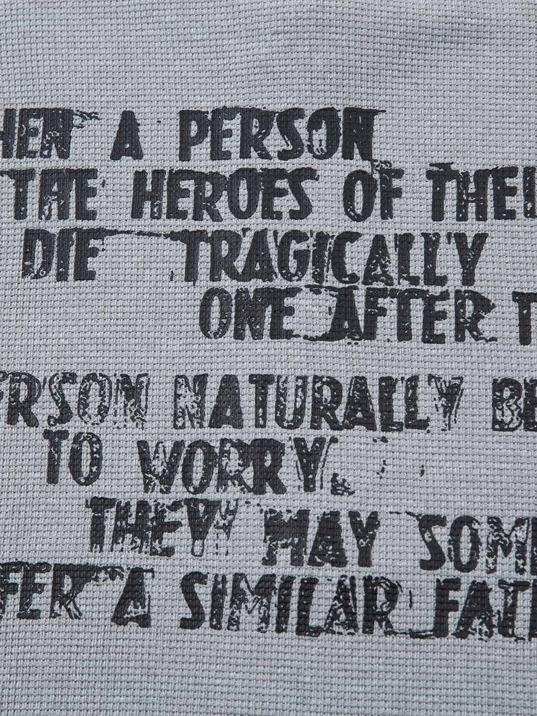 Detailed fabric and bold text on a TALISHKO T-shirt, highlighting its unique graphic design.