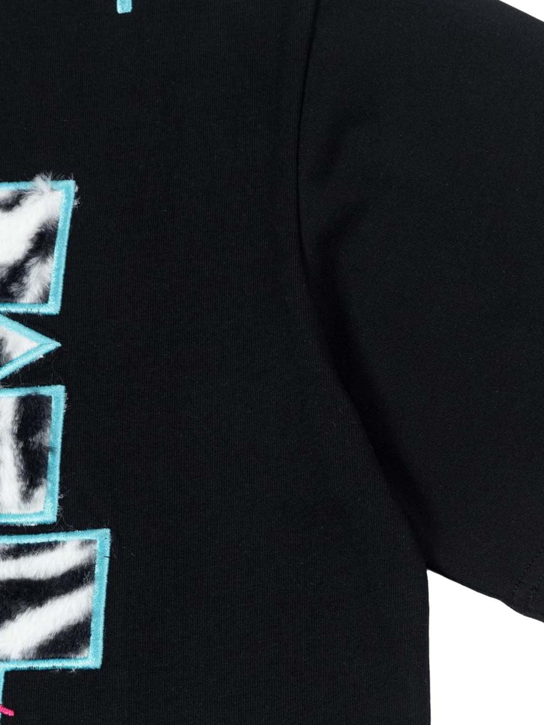 Detailed view of zebra print texture with turquoise accents on a TALISHKO graphic T-shirt.