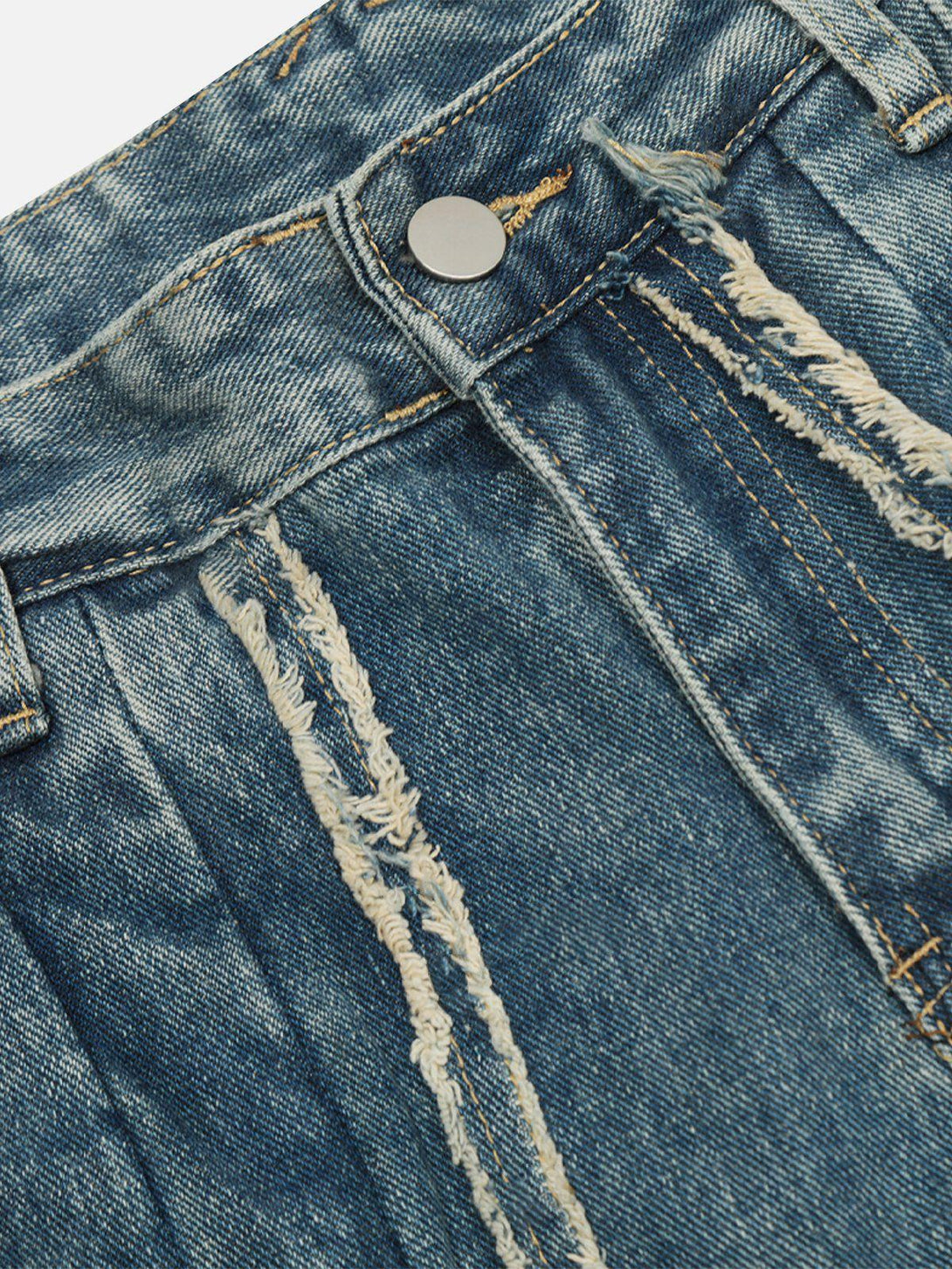 A close-up of TALISHKO's bow fringe washed jeans, highlighting distressed detailing and texture.