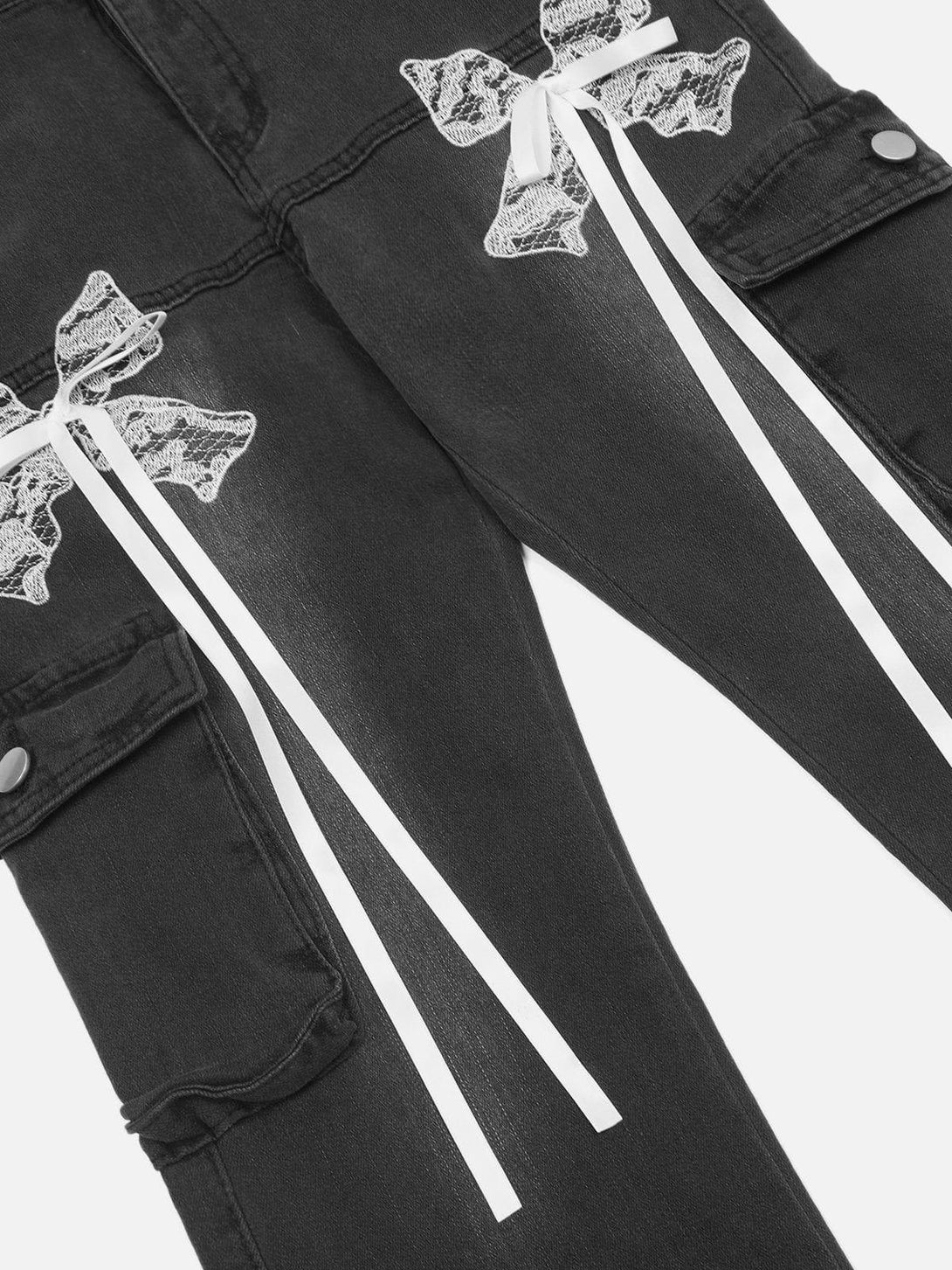 Intricate look at TALISHKO's washed jeans, showcasing lace bows and ribbons for a stylish touch.