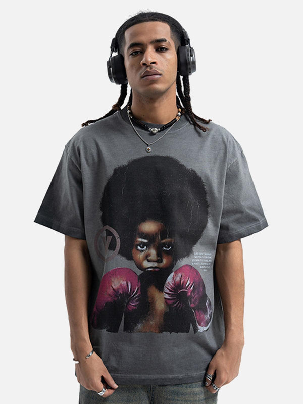 Model wearing a TALISHKO graphic T-shirt featuring a boxing boy design, showcasing urban style.