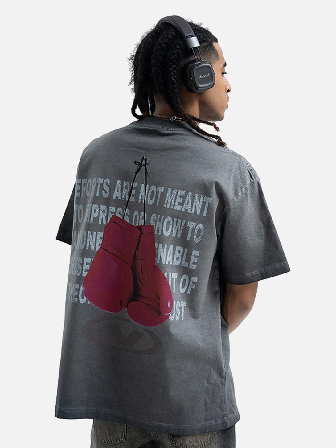 Model wearing a TALISHKO T-shirt with bold boxing gloves graphic on the back, highlighting casual style.