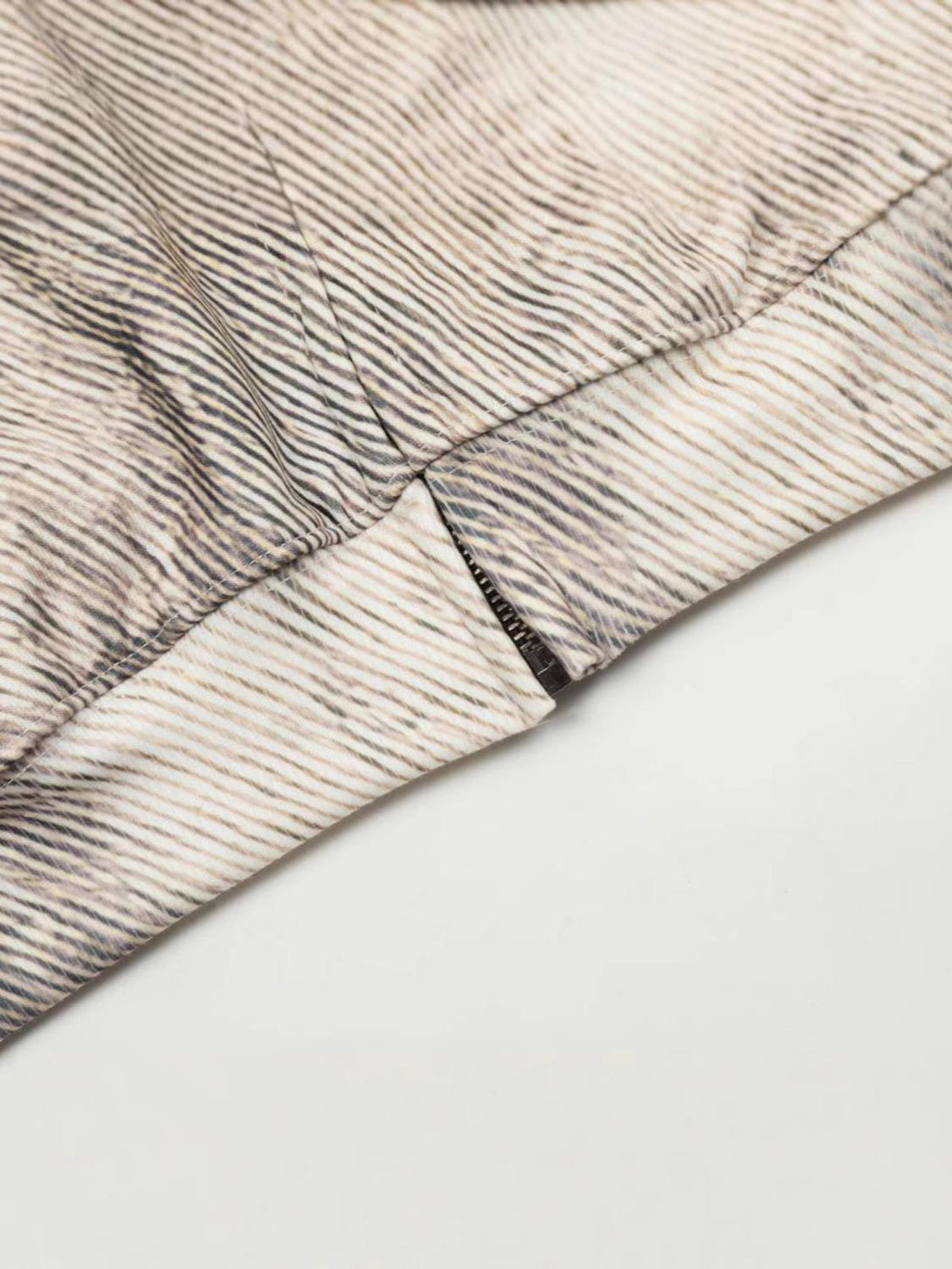 Zoomed-in texture of the branch-patterned hoodie by TALISHKO, highlighting intricate stitching.