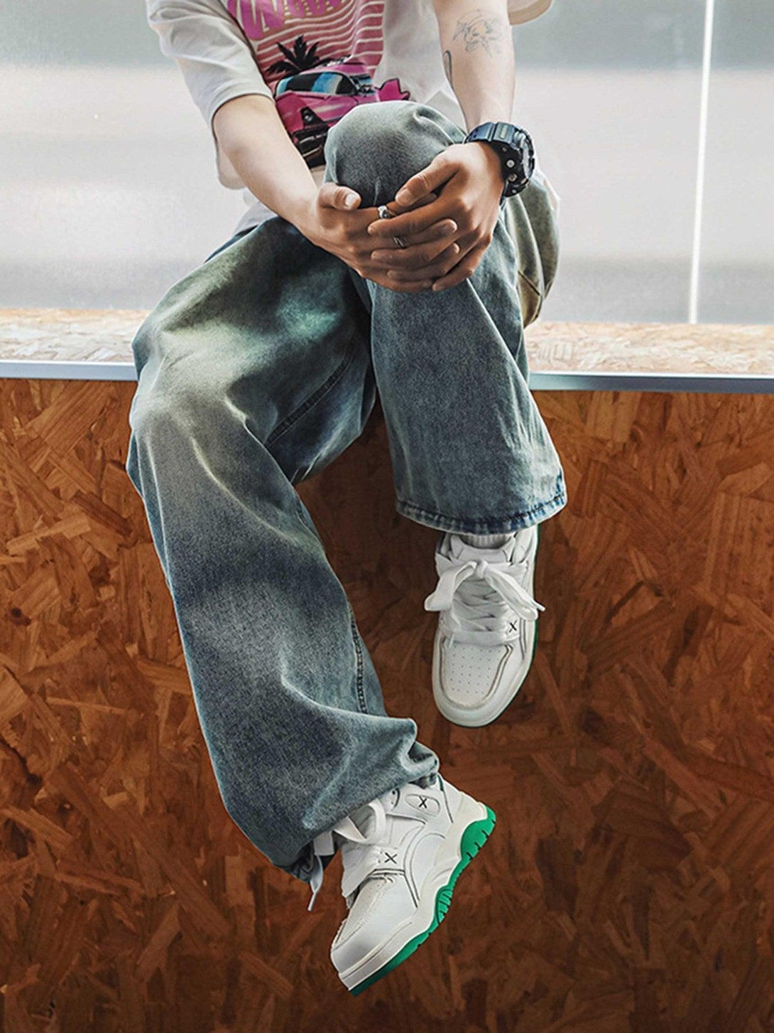 A trendy ensemble featuring TALISHKO board shoes with green soles, styled with relaxed denim.