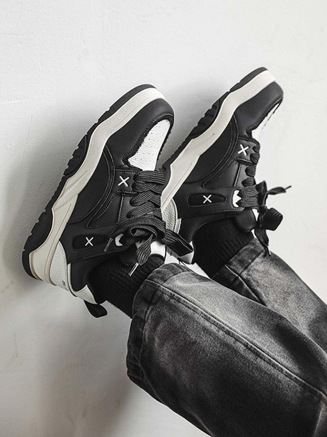 TALISHKO black and white board shoes with thick soles, paired with casual denim for style.