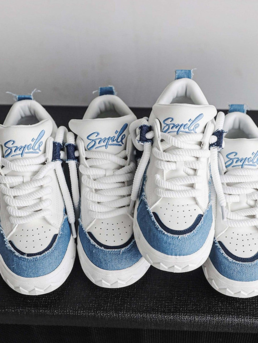 Stylish denim-accented sneakers by TALISHKO, showcasing a unique blend of white and blue design.