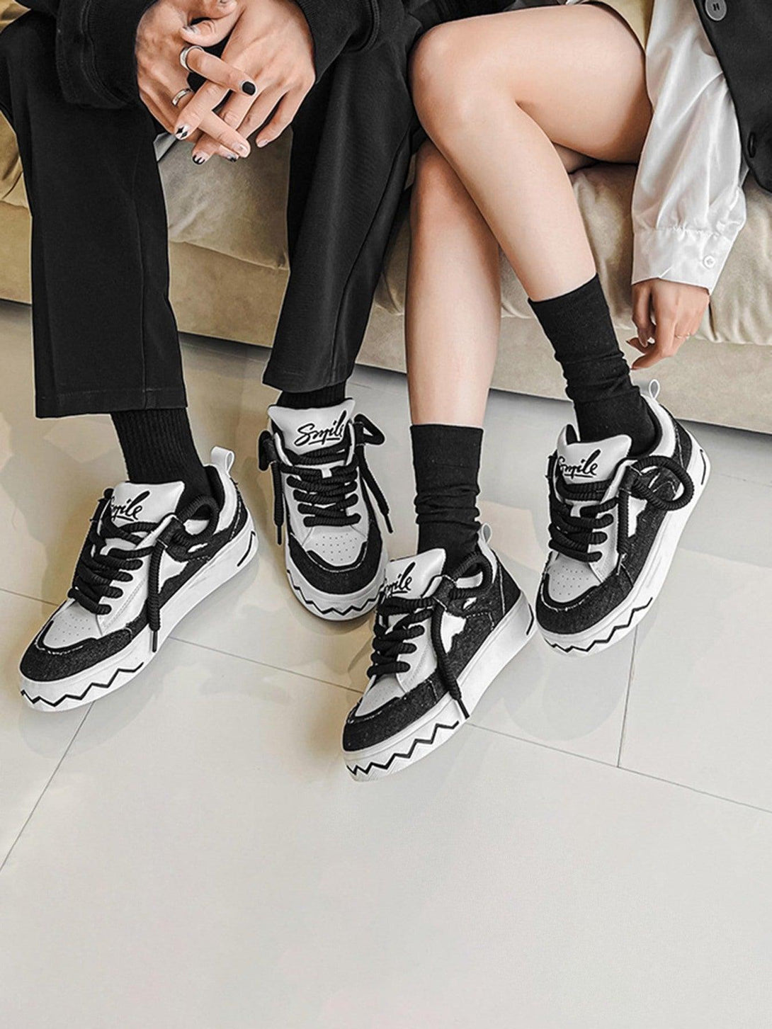 TALISHKO canvas sneakers in black and white, styled with zigzag soles for a chic look.