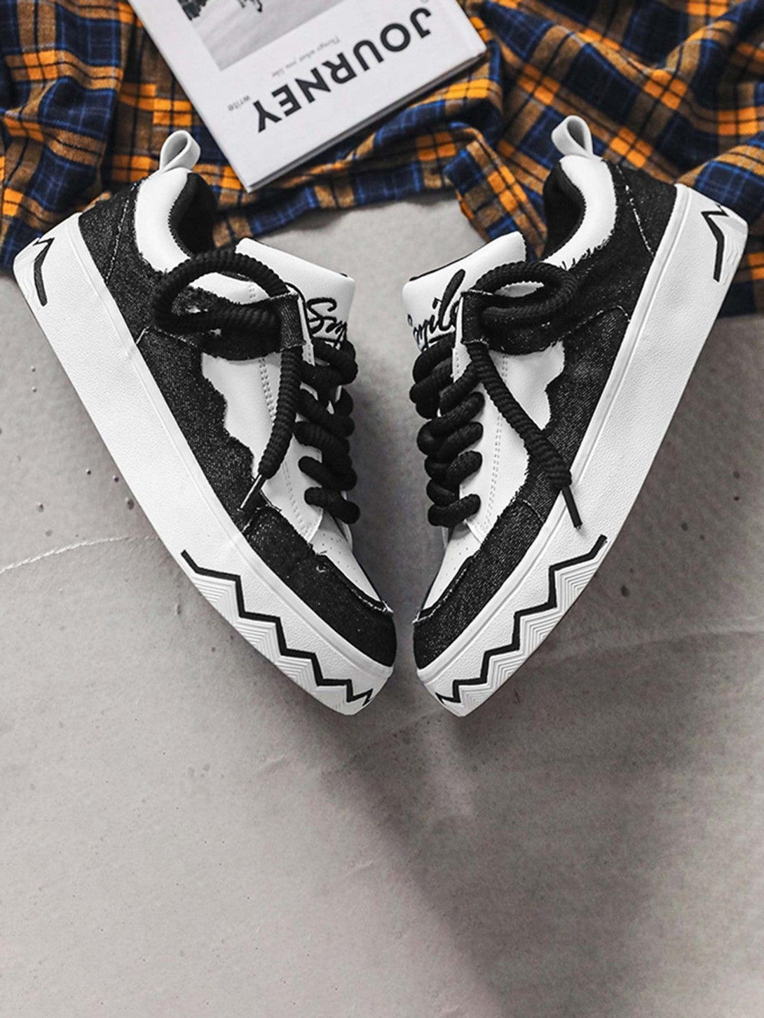 TALISHKO canvas shoes with bold zigzag soles and black-white contrast, perfect for a trendy look.