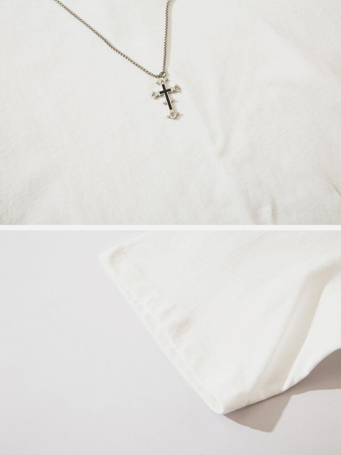 A close-up of TALISHKO's Broken Chain Decoration Tee, featuring a cross chain accent.
