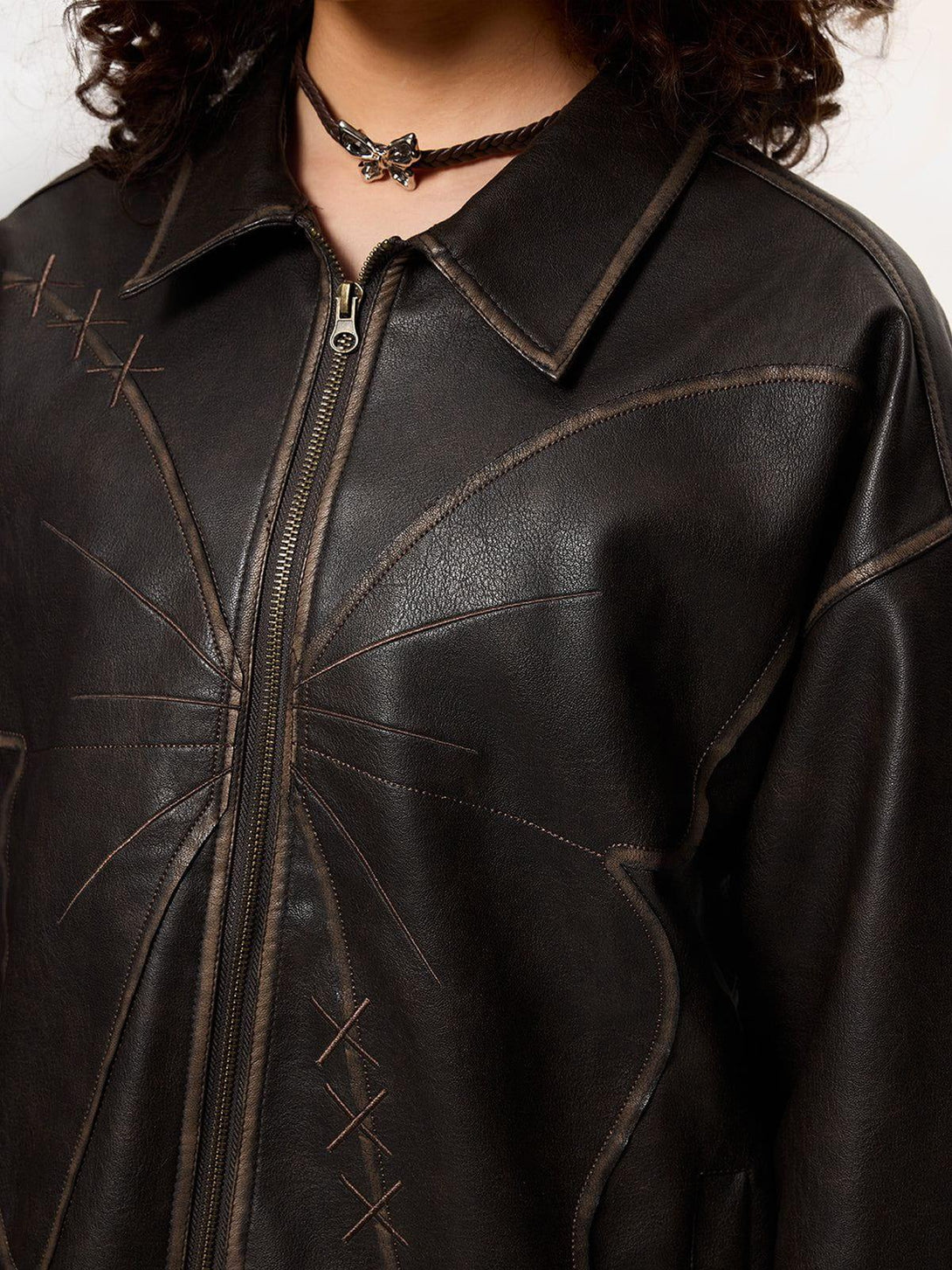Intricate stitching detail on TALISHKO's butterfly faux leather jacket, highlighting unique design.