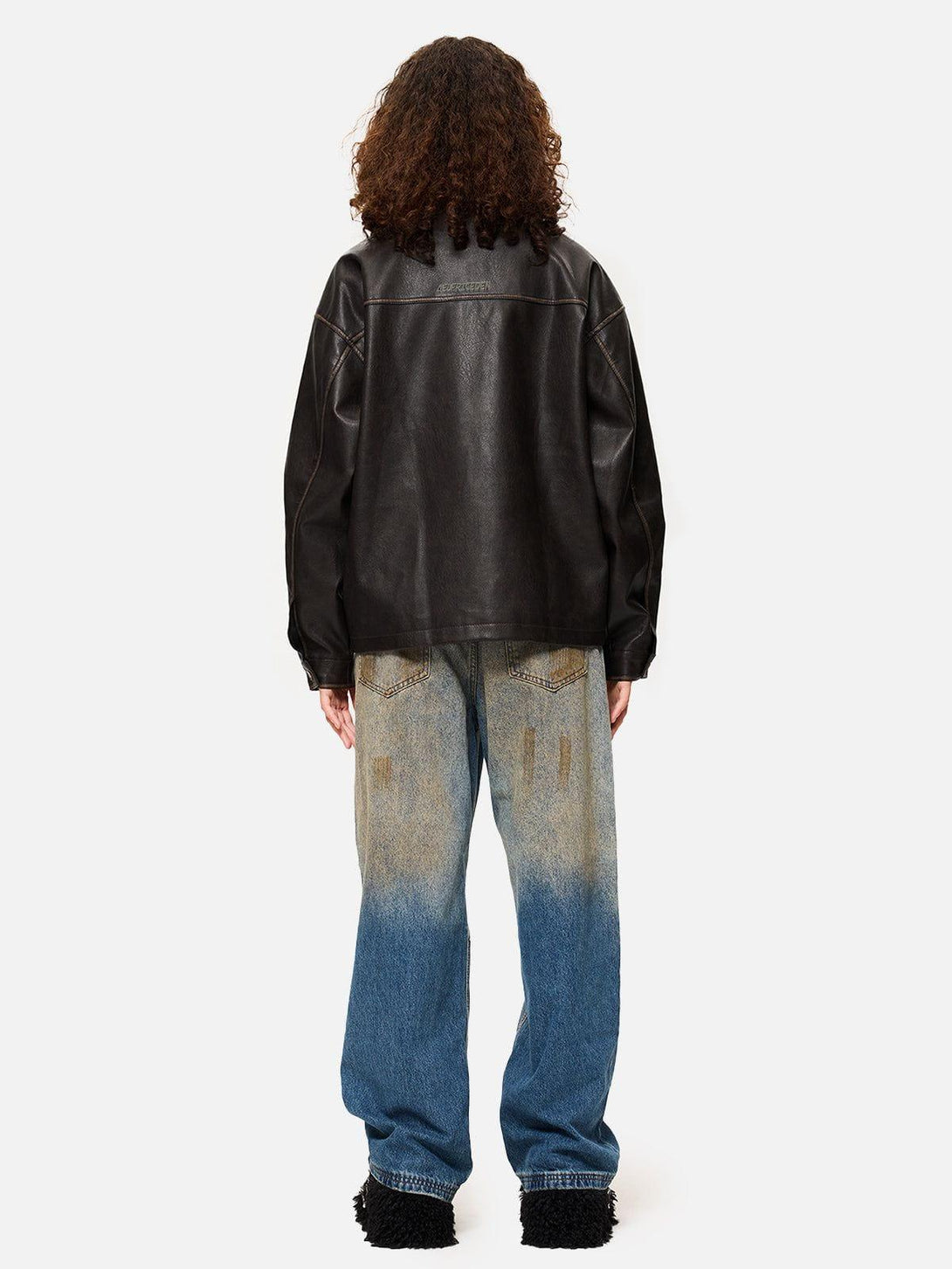 Back view of TALISHKO butterfly faux leather jacket paired with faded jeans for a chic look.