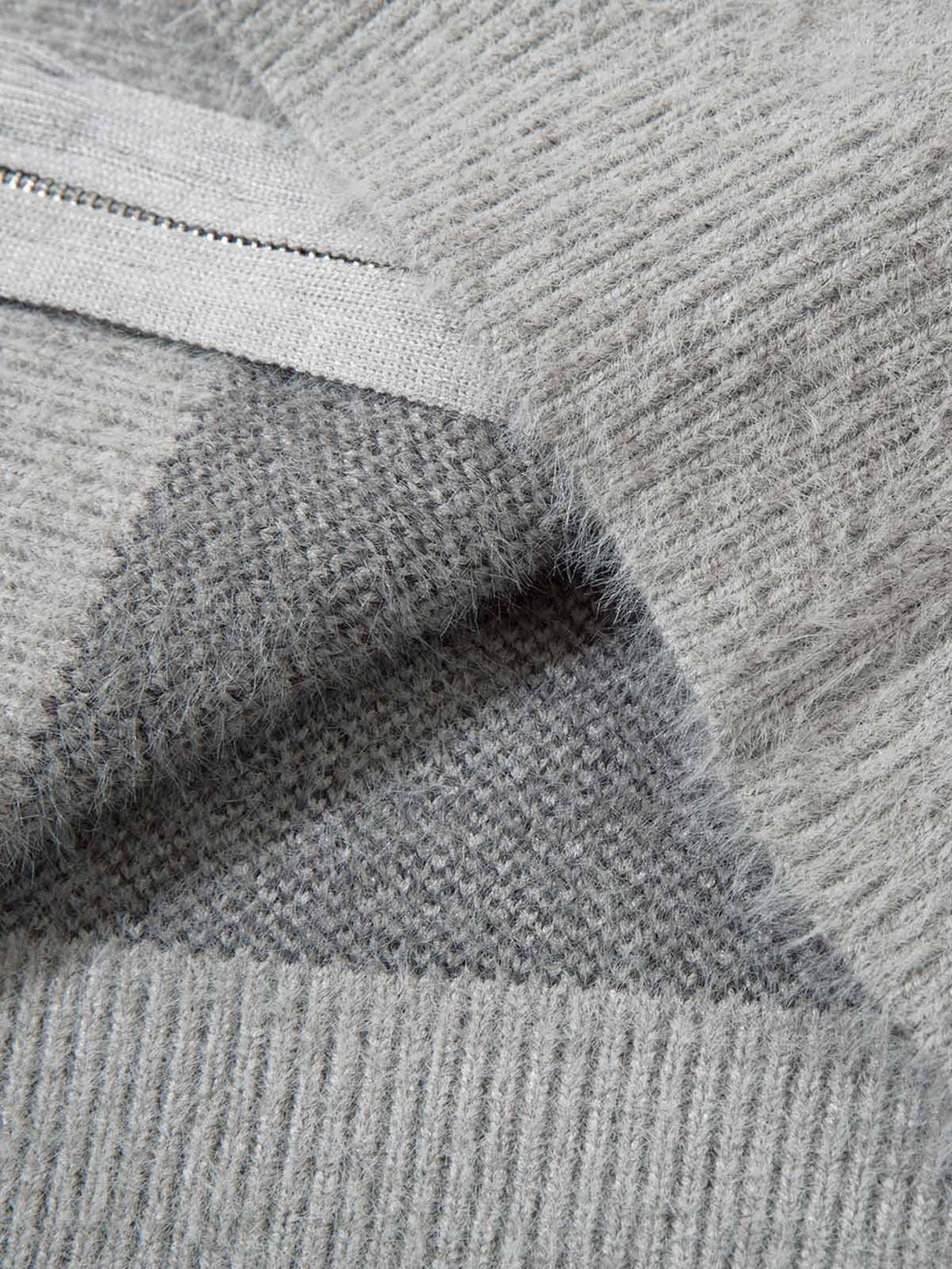 Intricate look at the gray knit texture of TALISHKO's butterfly jacquard mock neck sweater.