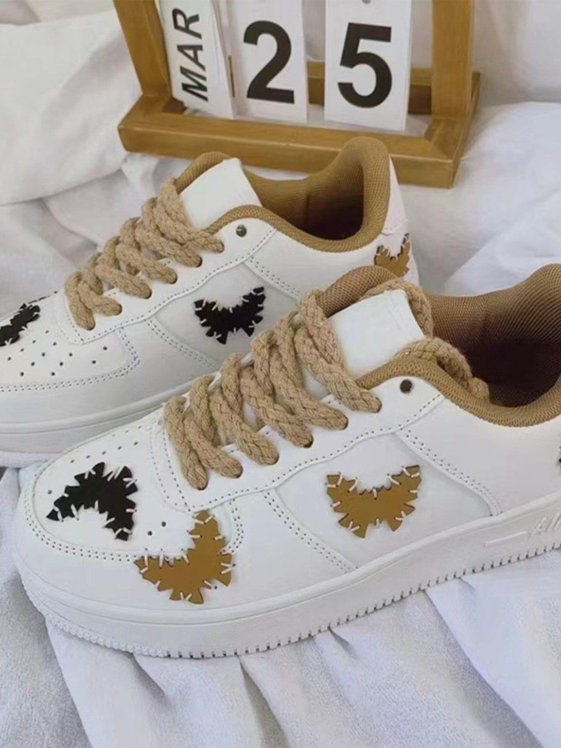 TALISHKO skate shoes with bold butterfly accents and textured laces, adding flair to casual wear.