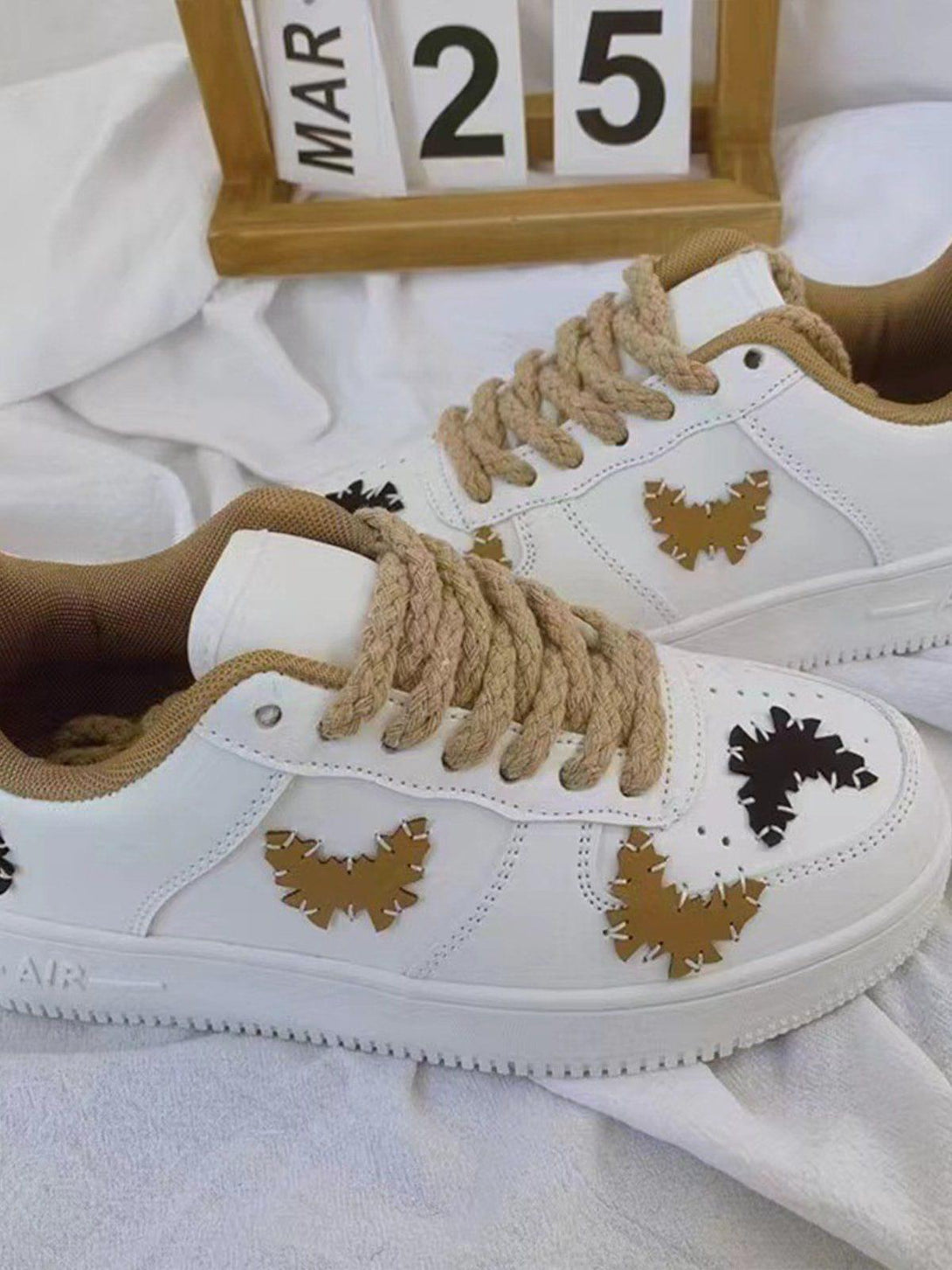 TALISHKO skate shoes with eye-catching butterfly details and thick laces, perfect for street style.