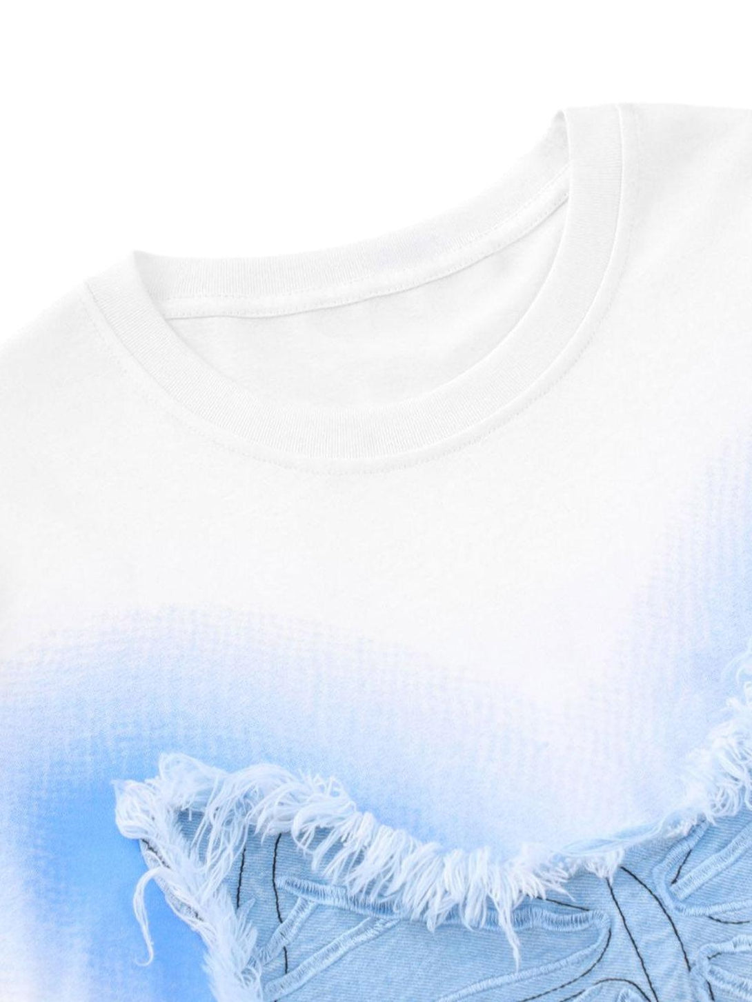 Zoomed-in view of the embroidered butterfly patch on a TALISHKO T-shirt, highlighting texture.