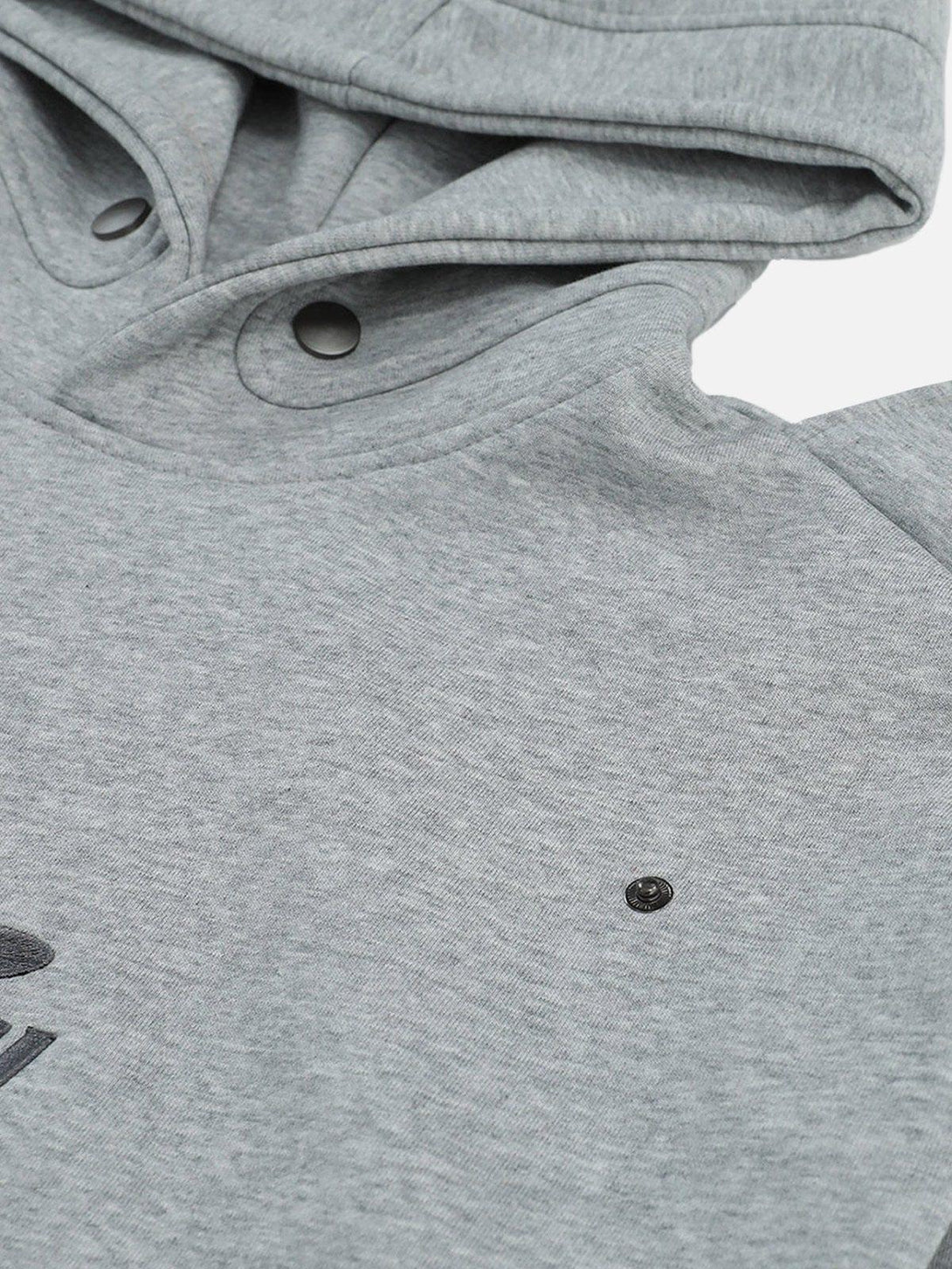 Detailed view of a gray button deconstructive hoodie by TALISHKO, highlighting unique design elements.