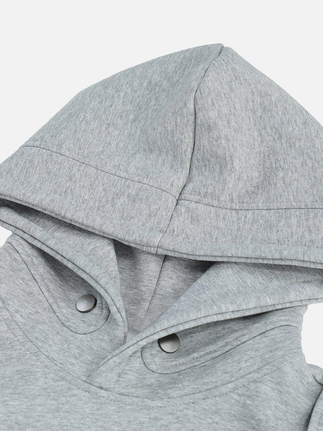 A close-up of the gray button deconstructive hoodie by TALISHKO, highlighting its stylish hood design.