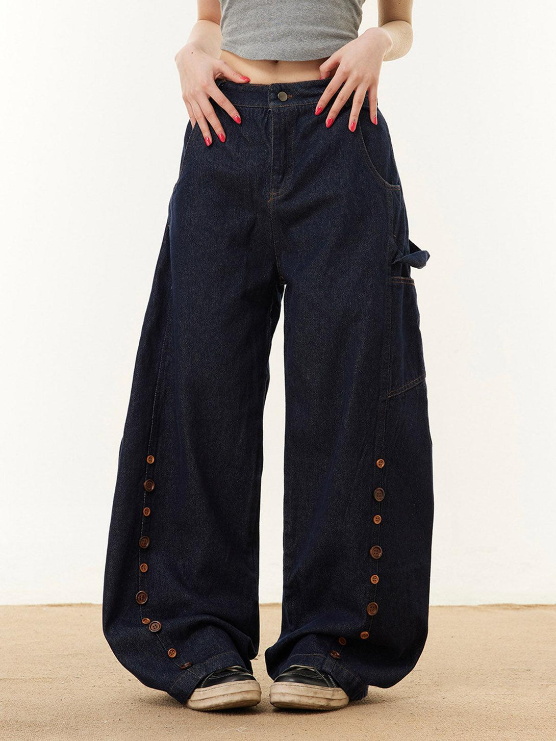 Wide-leg barrel jeans by TALISHKO with button detail, modeled front view for a casual look.