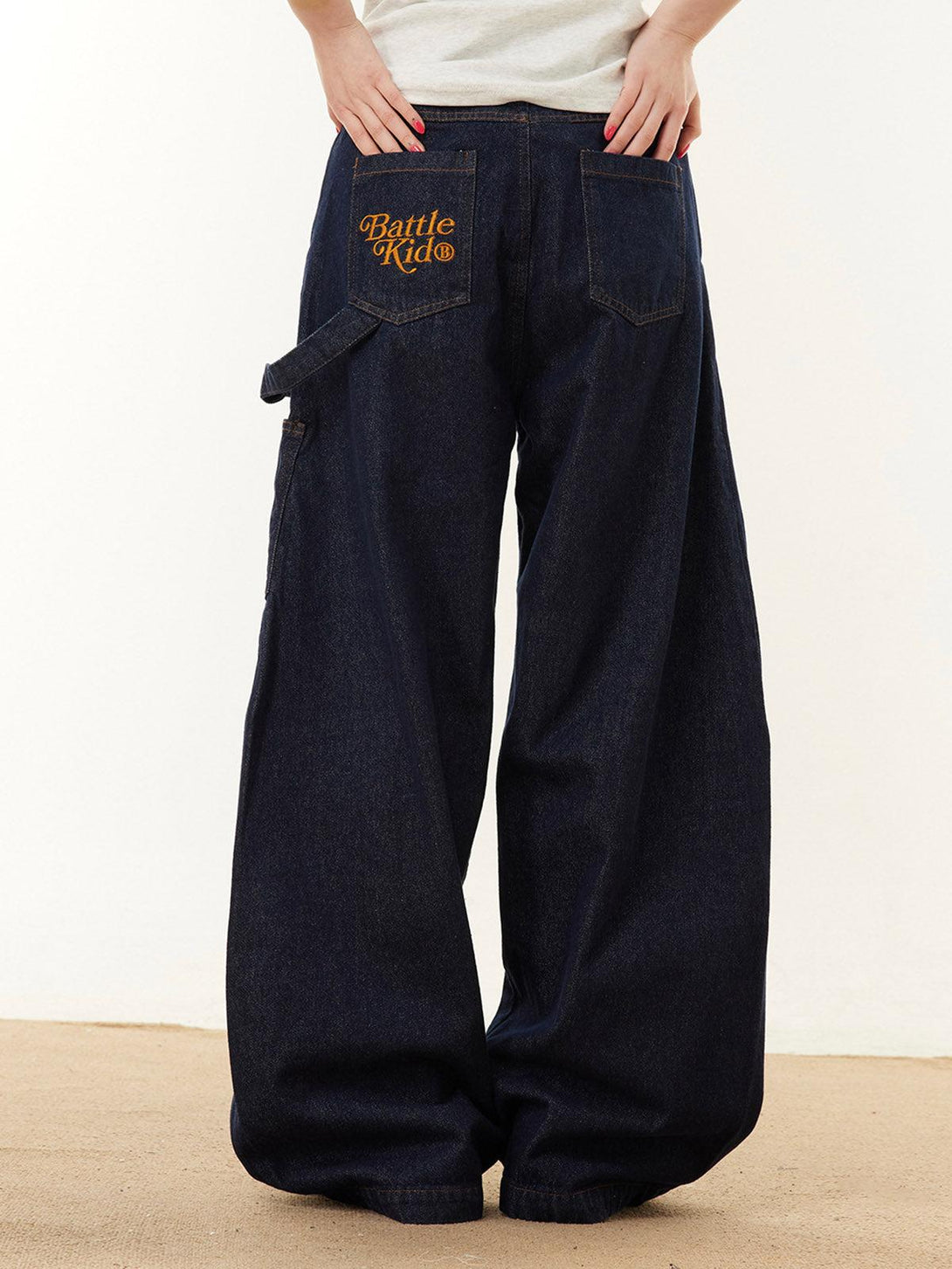 Back view of navy barrel jeans by TALISHKO, featuring embroidered details for a bold style.