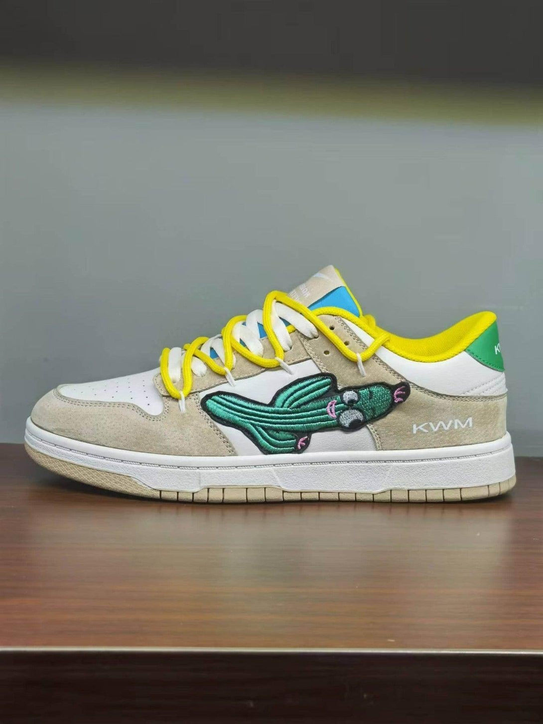 TALISHKO board shoes with cactus design, yellow laces, and suede accents, viewed from the side.