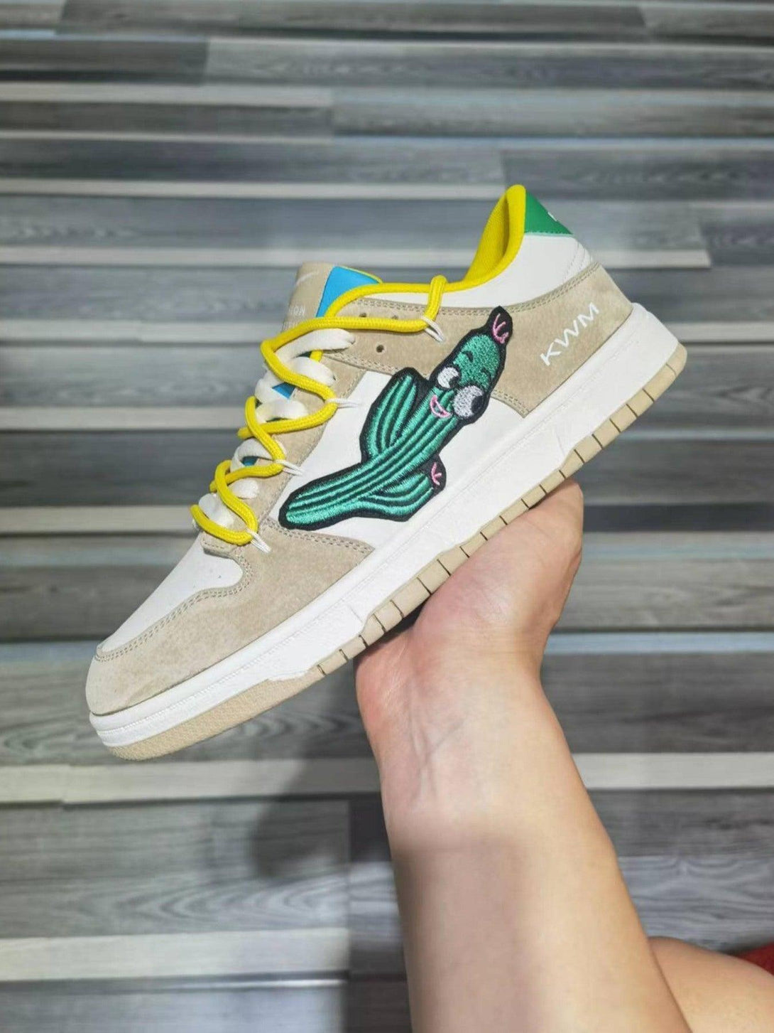 TALISHKO board shoes highlighting a playful cactus design and vibrant yellow laces, side view.