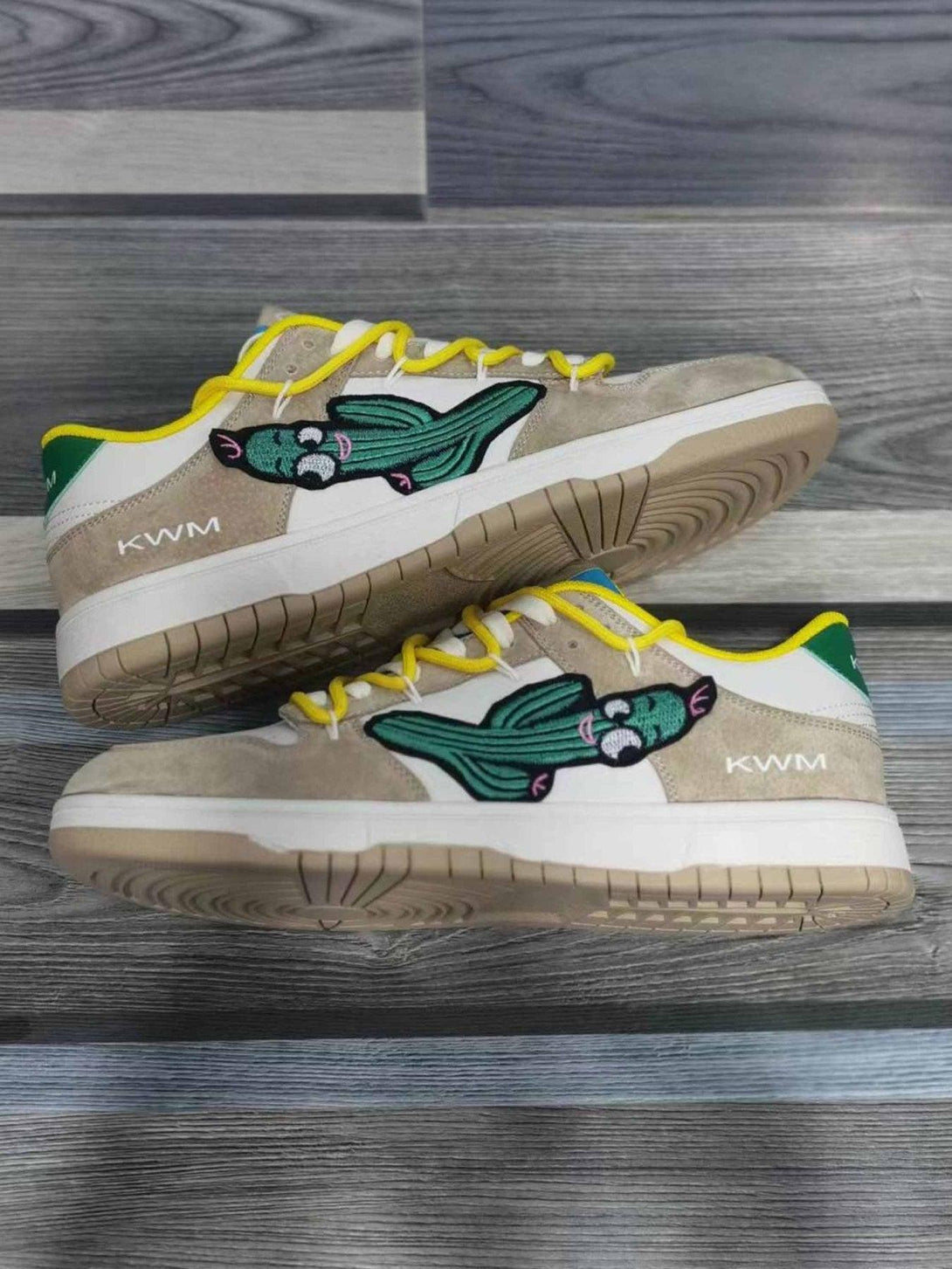 TALISHKO board shoes with cactus design and yellow laces, side view on wooden floor.