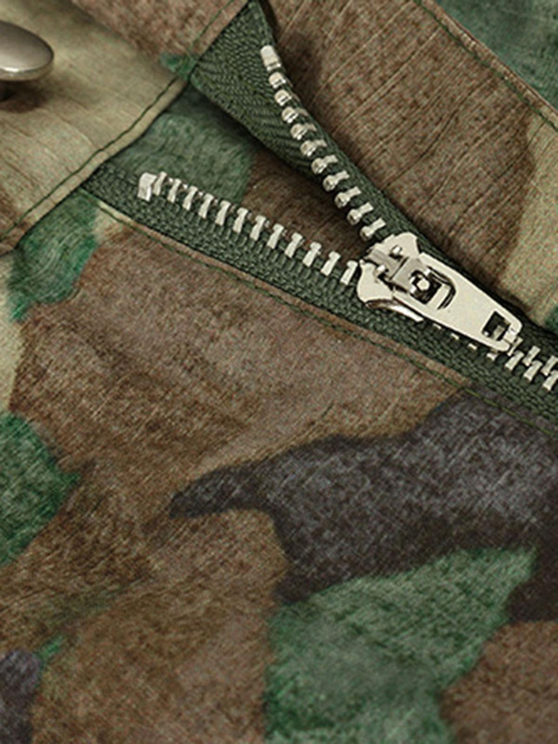 A detailed view of the zipper and fabric texture on TALISHKO camouflage cargo pants.
