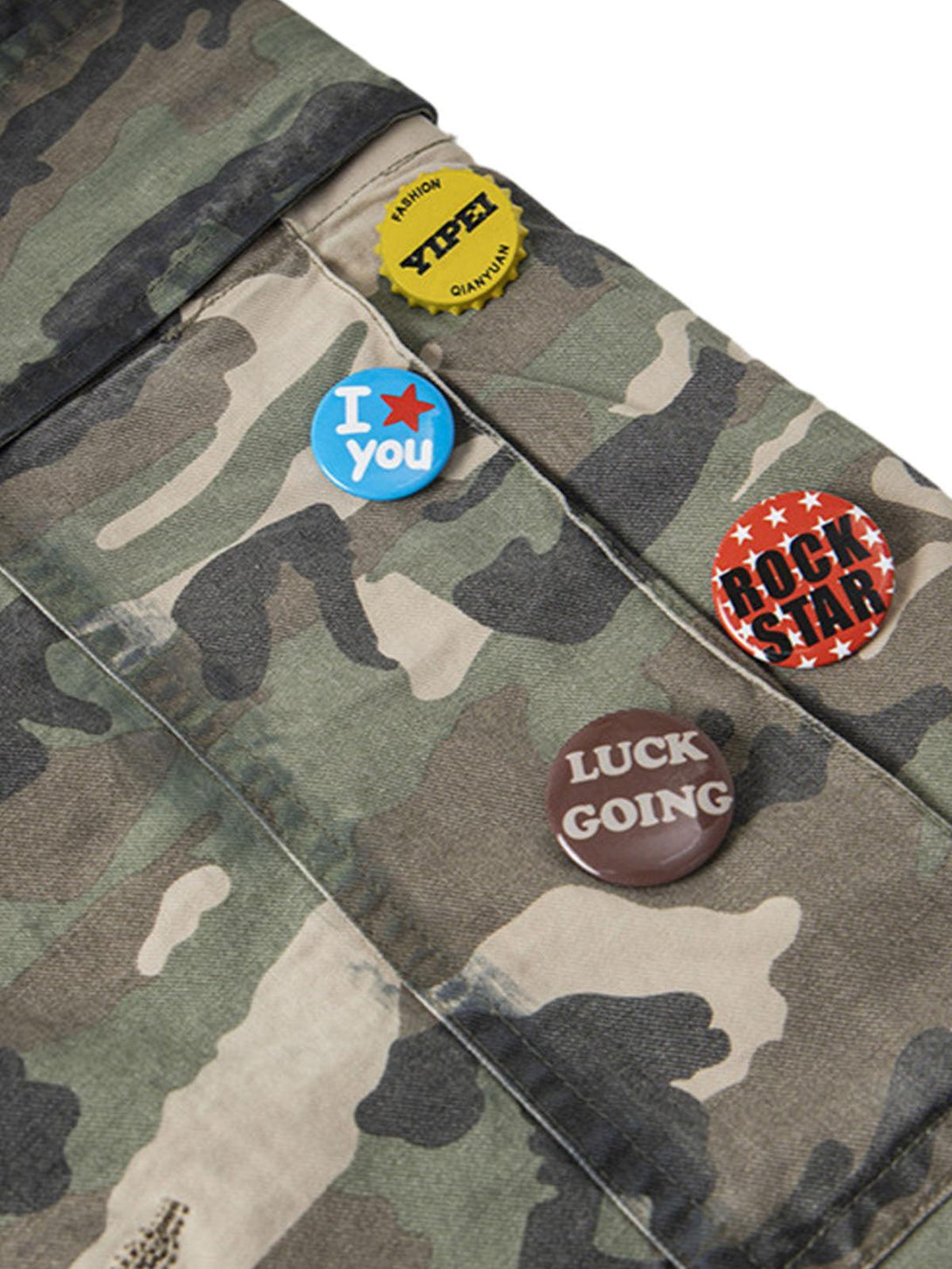 Zoomed-in view of TALISHKO camouflage cargo shorts showcasing unique badge details.