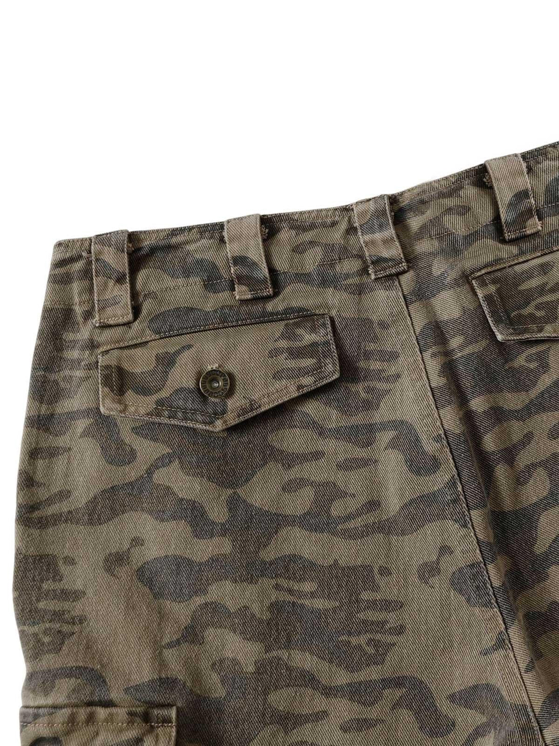 Zoomed-in view of TALISHKO camouflage cargo pants showing intricate pocket and button details.