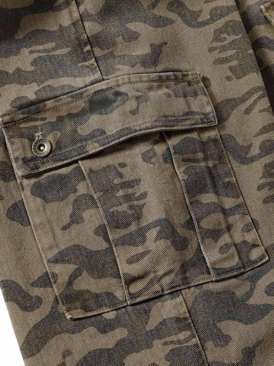 A close-up of TALISHKO camouflage cargo pants highlighting the pocket and rugged fabric design.