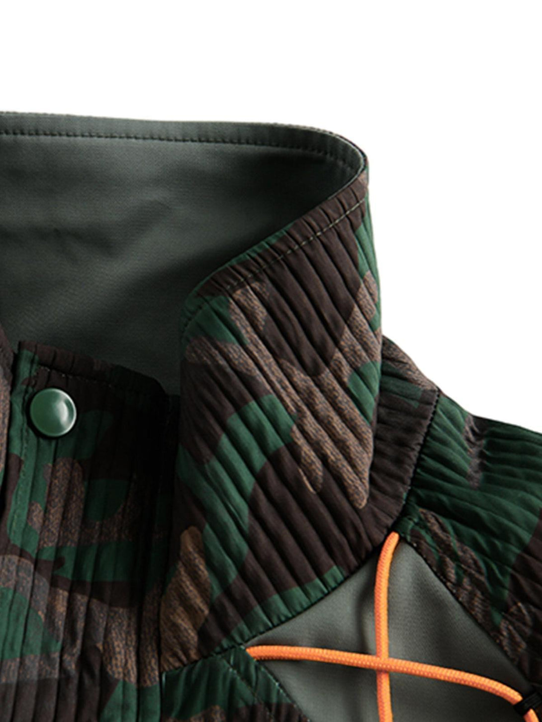 Detailed view of TALISHKO's camouflage patchwork jacket, highlighting fabric texture and design.