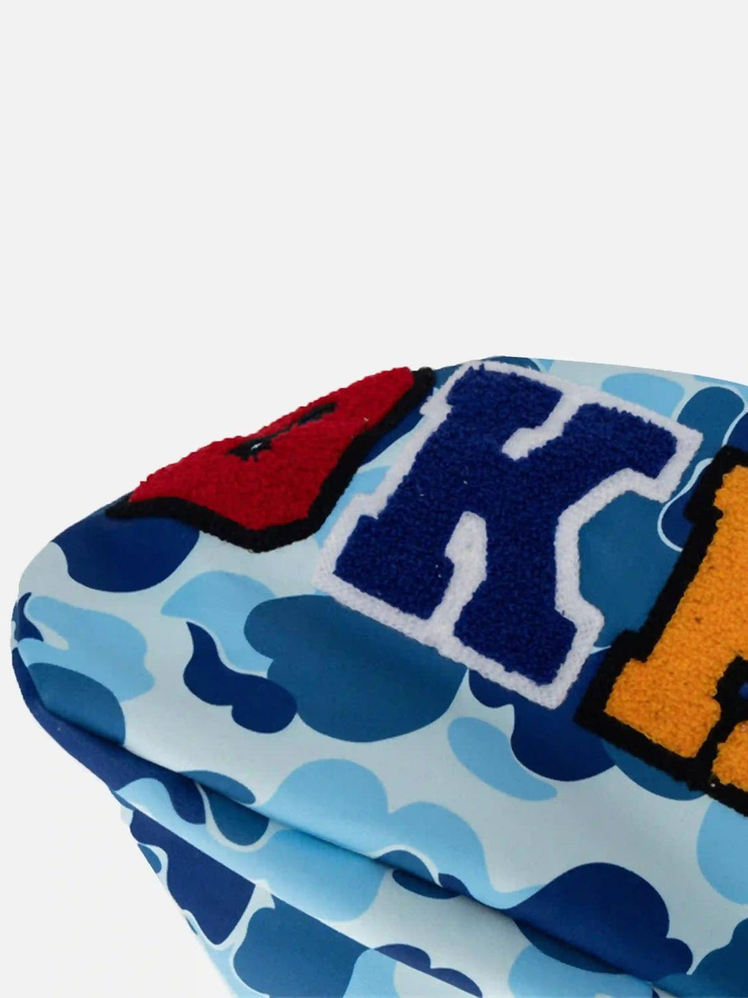 A detailed look at the vibrant lettering and camouflage pattern on TALISHKO's hoodie.