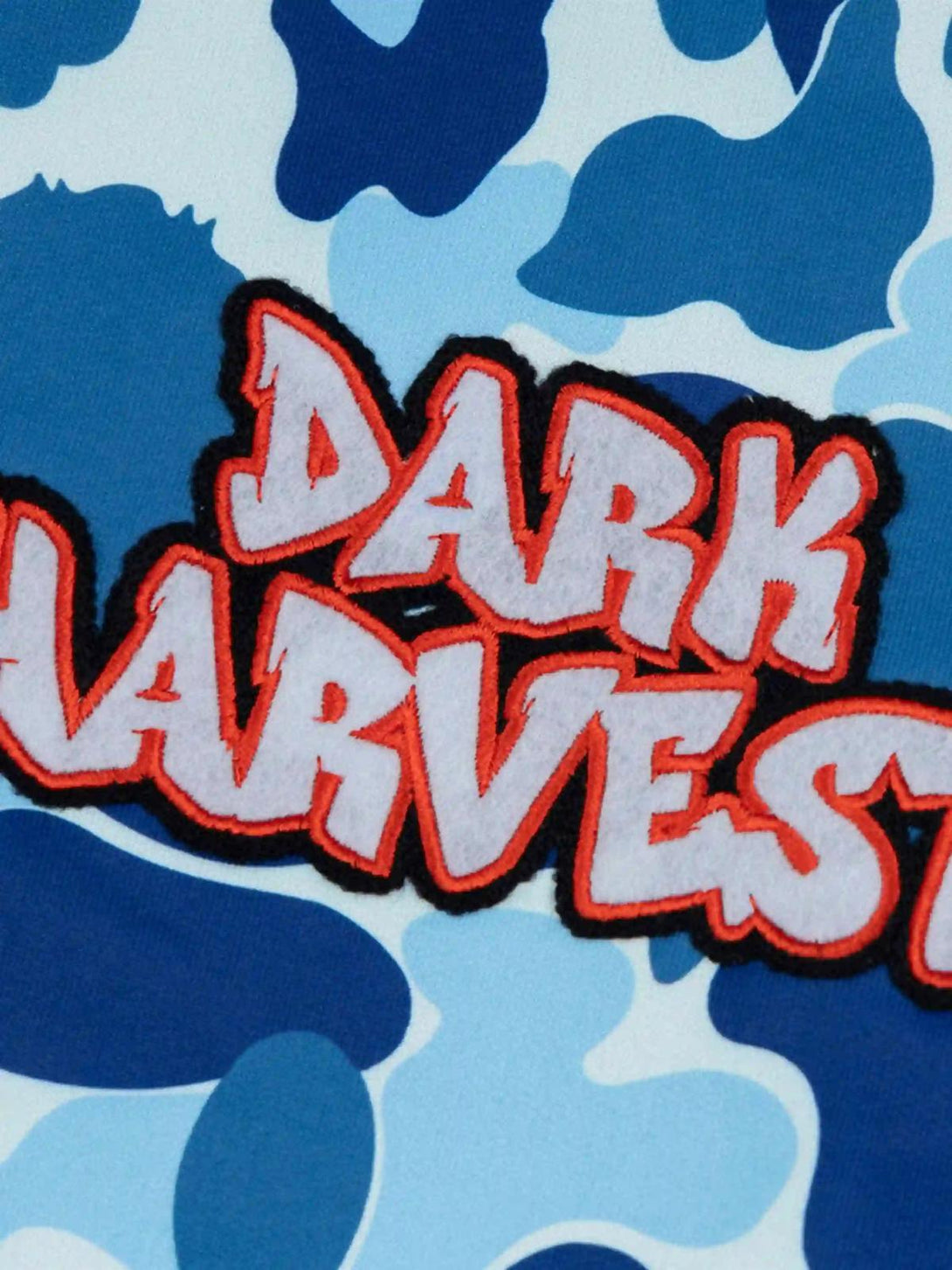 "Bold lettering and blue camouflage pattern detail on TALISHKO's stylish hoodie."