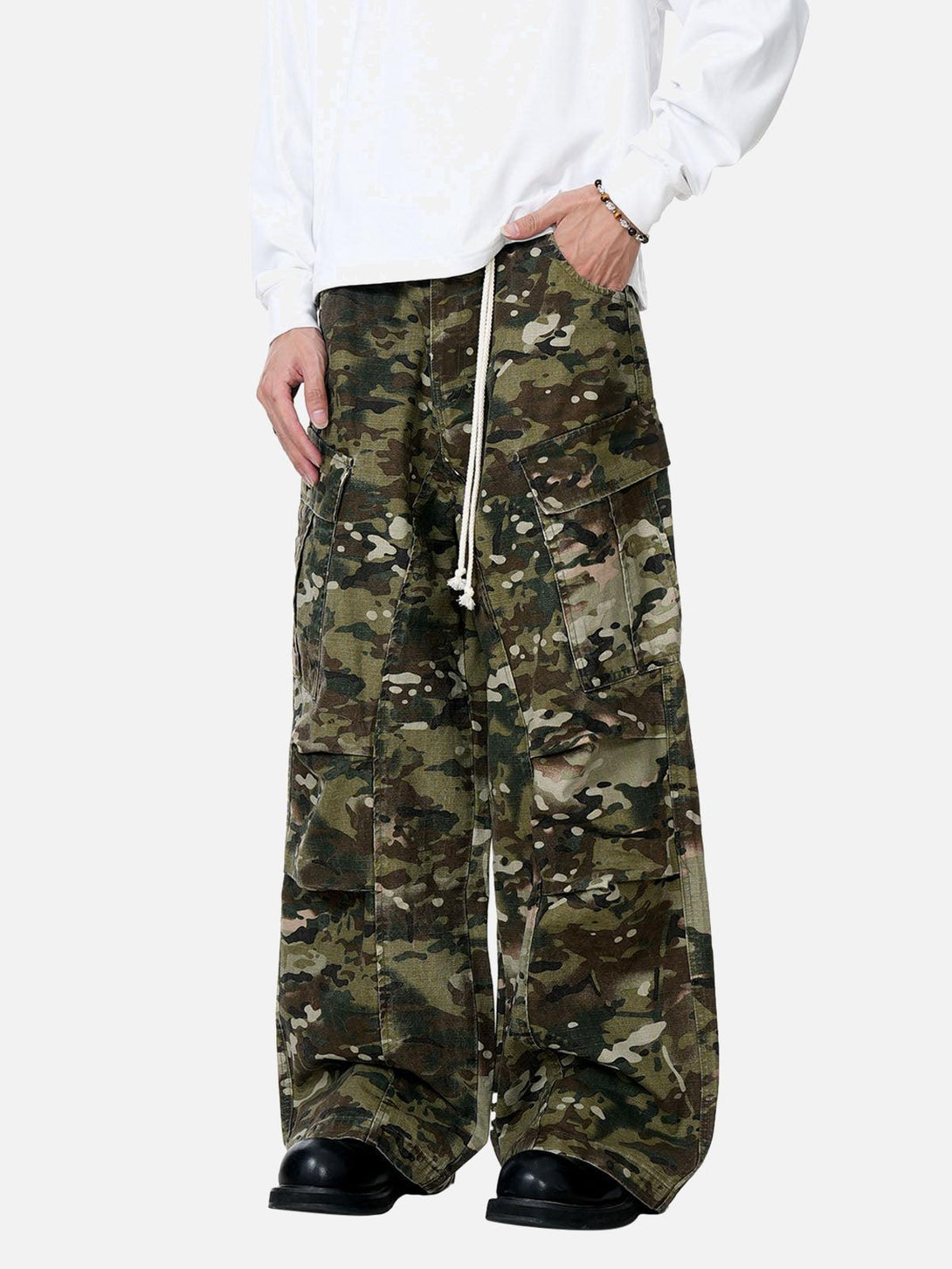 Model in TALISHKO camouflage cargo pants, featuring a relaxed fit and drawstring detail.