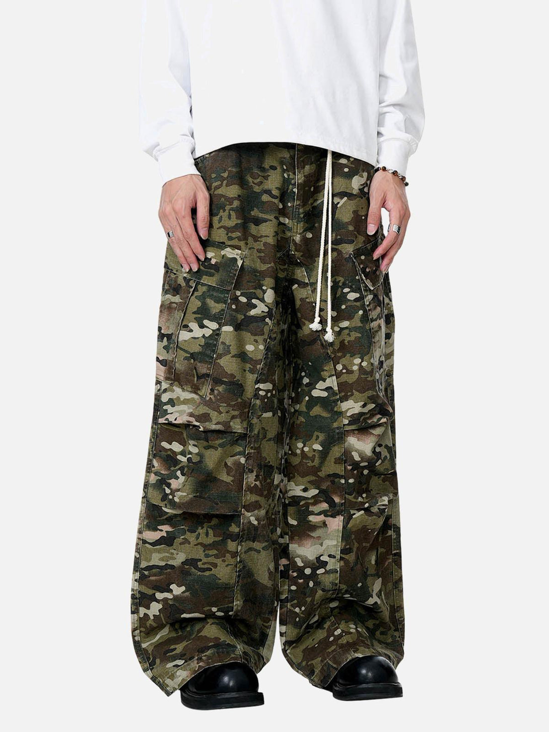 TALISHKO camouflage cargo pants with drawstring, worn by model, highlight a relaxed urban style.