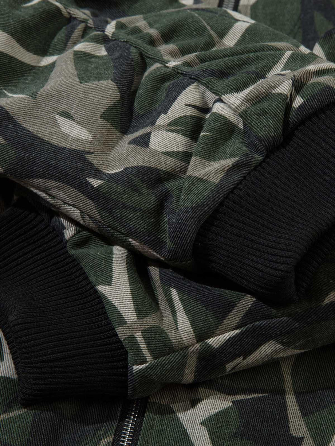 Texture and pattern showcased on TALISHKO's camouflage bomber jacket, highlighting design details.