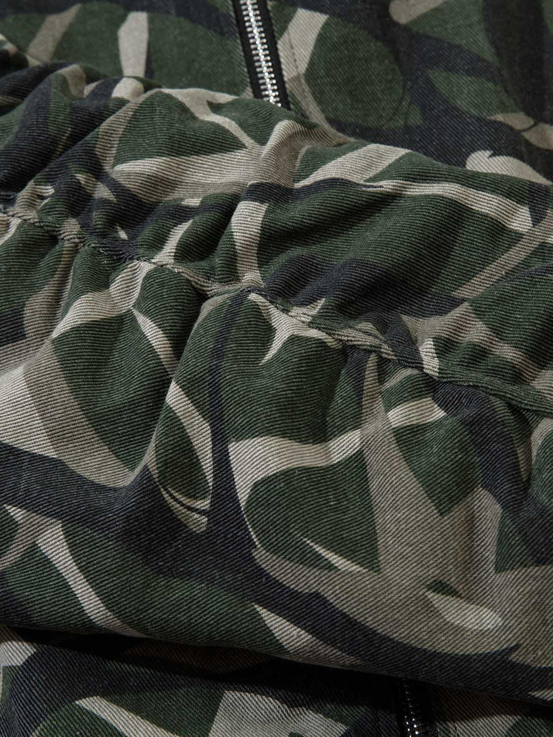 Focusing on the unique camouflage pattern and fabric texture of TALISHKO's bomber jacket.