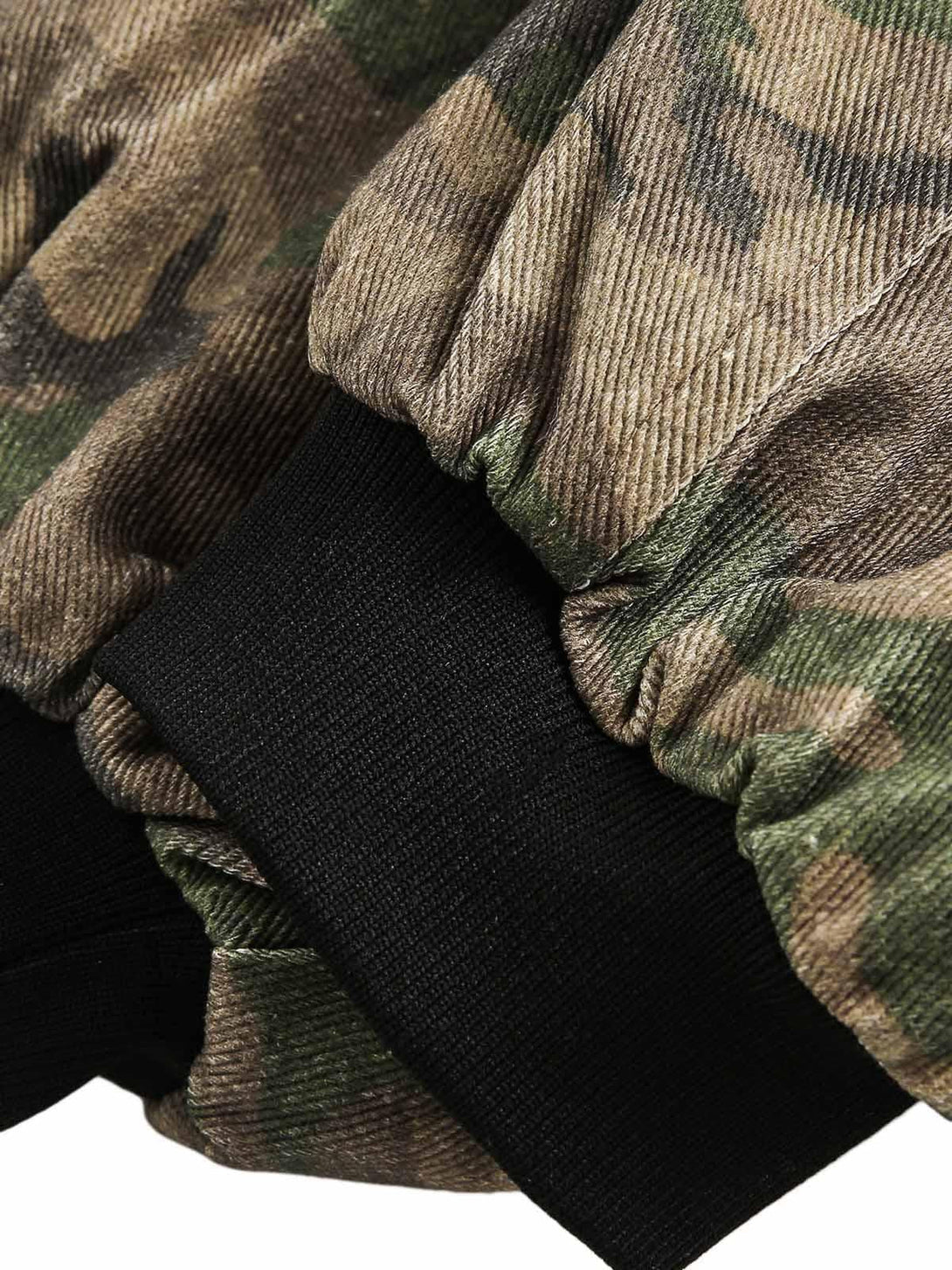 A tight crop highlighting TALISHKO camouflage jacket's cuff, showcasing its textured fabric.