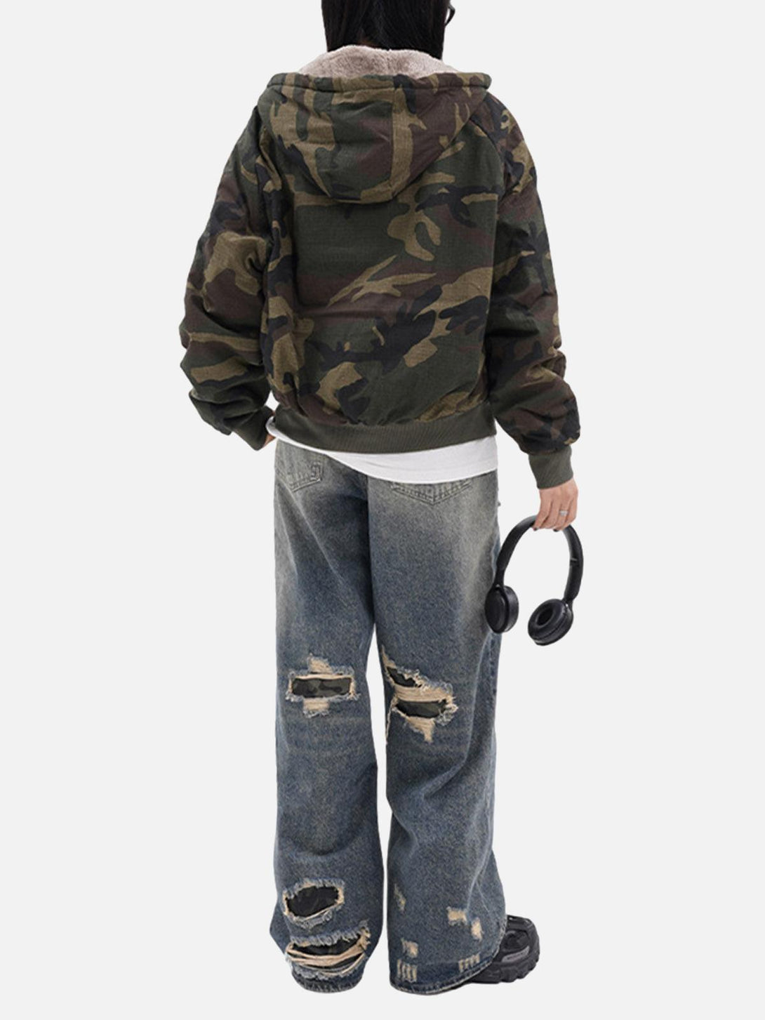 Back view of a camouflage fleece hooded jacket by TALISHKO, styled with distressed jeans.