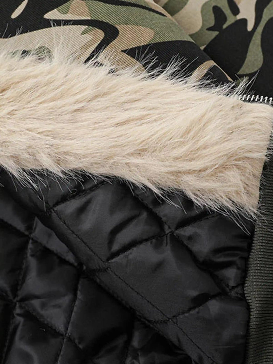 A detailed view of TALISHKO's camouflage hoodie, highlighting its cozy fur lining and quilted interior.