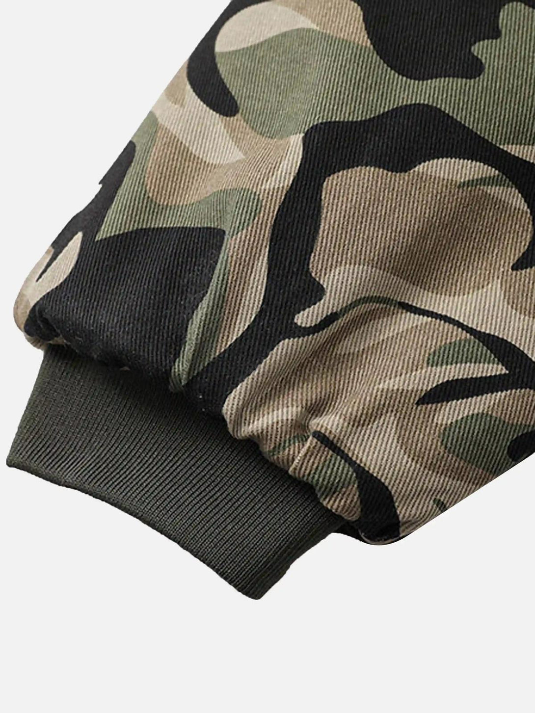 Intricate look at the ribbed cuff of TALISHKO's camouflage hoodie, highlighting its texture.