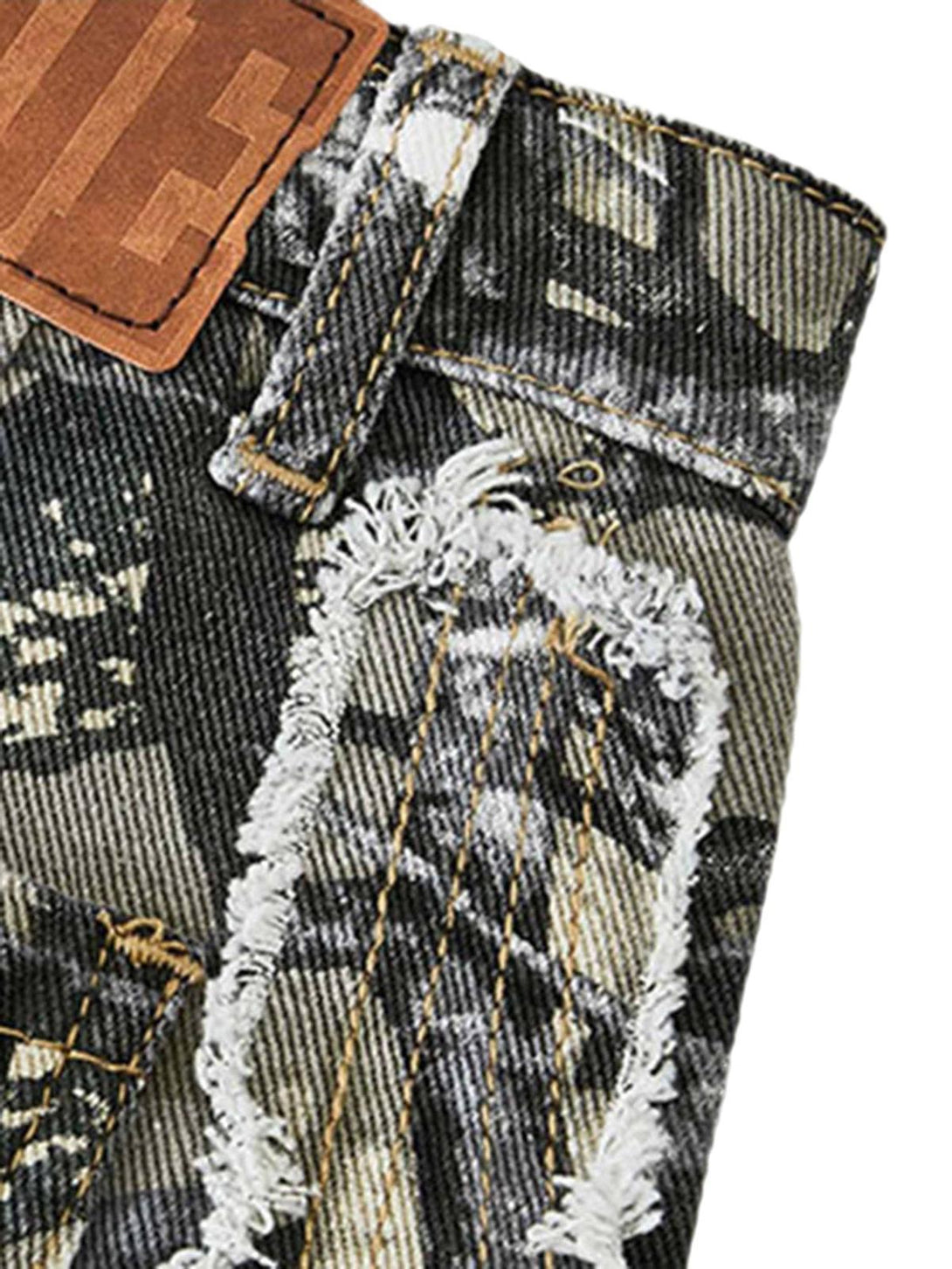 A close-up of TALISHKO camouflage leaf pants, highlighting distressed details and stitching.