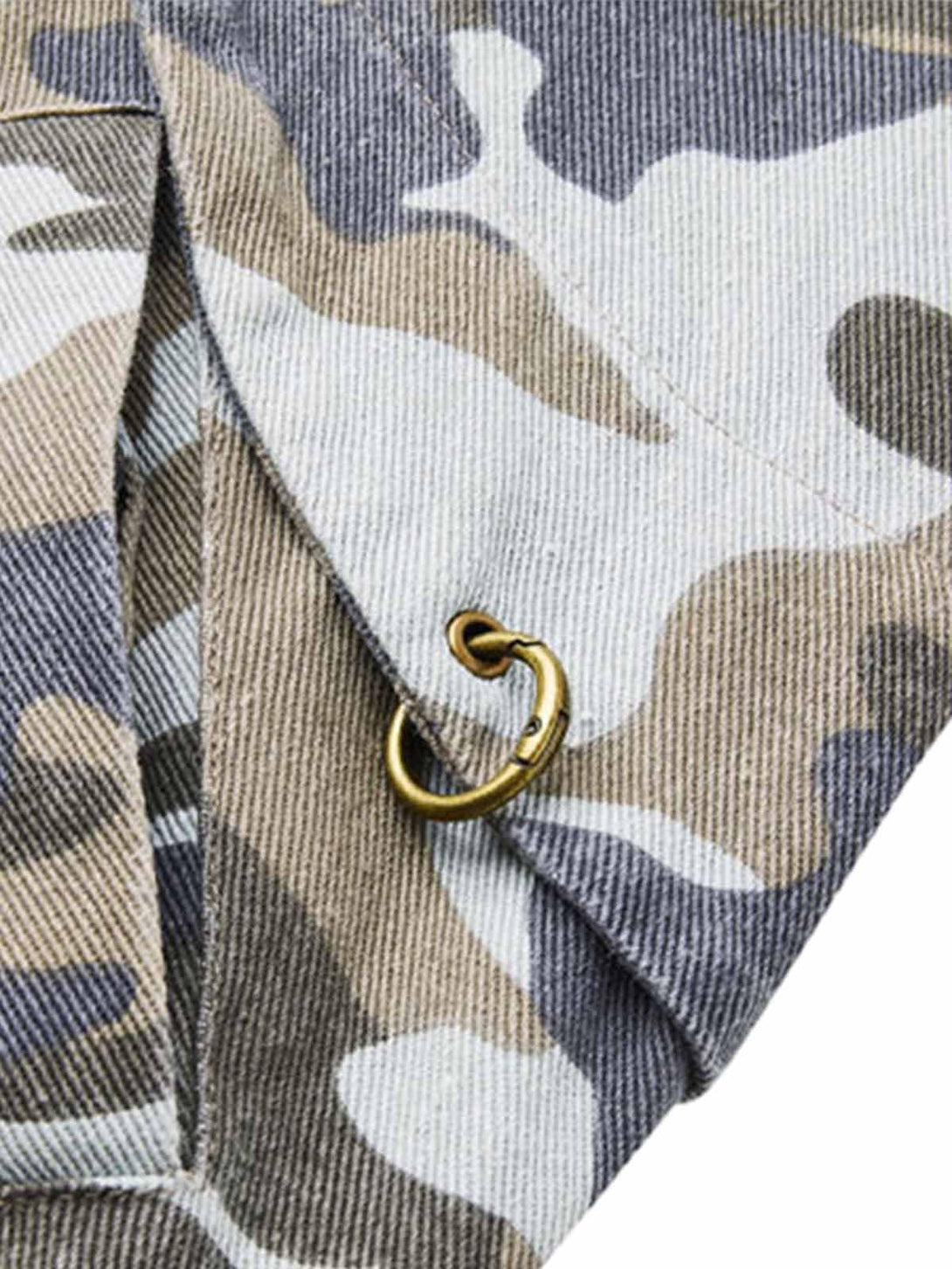 Detailed fabric and stitching of a TALISHKO camouflage bomber jacket highlighting brass accents.