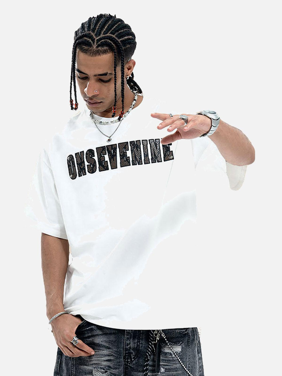 Model styled in a TALISHKO white T-shirt with distinctive camouflage lettering and accessories.