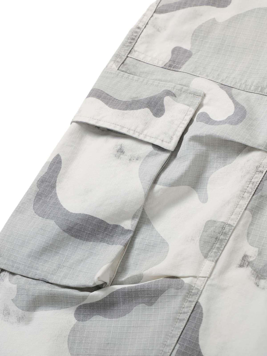 A close-up of TALISHKO's camouflage cargo shorts, showing the multi-pocket fabric detail.